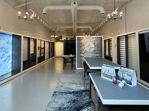 Store interior showcasing several different types of window coverings