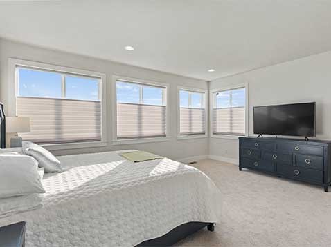 Bright bedroom showcasing motorized blinds